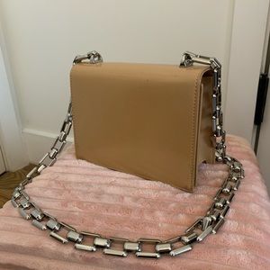 Tan boxy flap bag on chunky chain